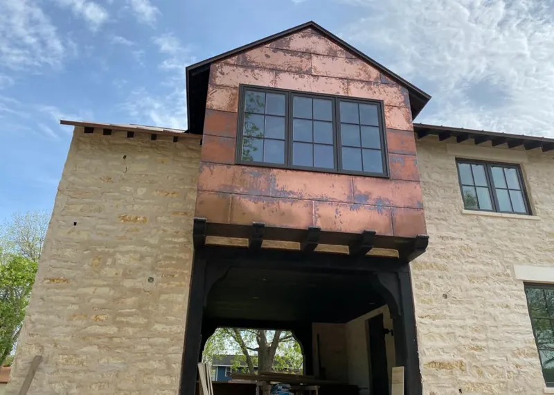 Copper metal panel facade on a stone building for Roof Repair in Walnut