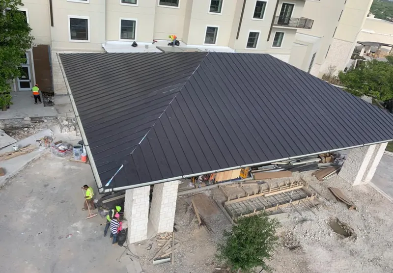 Metal roofing installation team working on a commercial building in Walnut